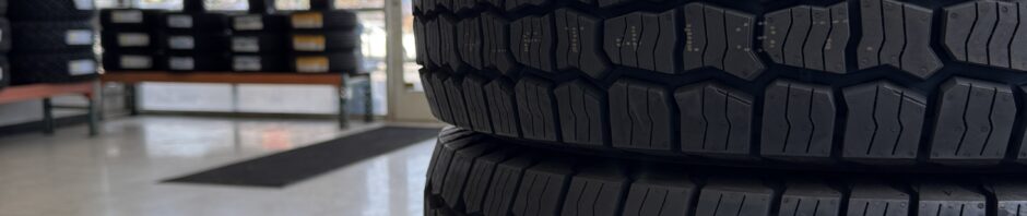 Generic tire service waiting area view with stacks of tires.